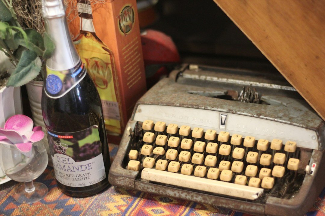 Vintage typewriter on a wooden desk lit by candlelight in a dim study